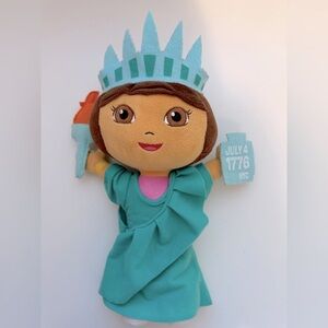 Dora the Explorer plush doll dressed as the Statue of Liberty.
